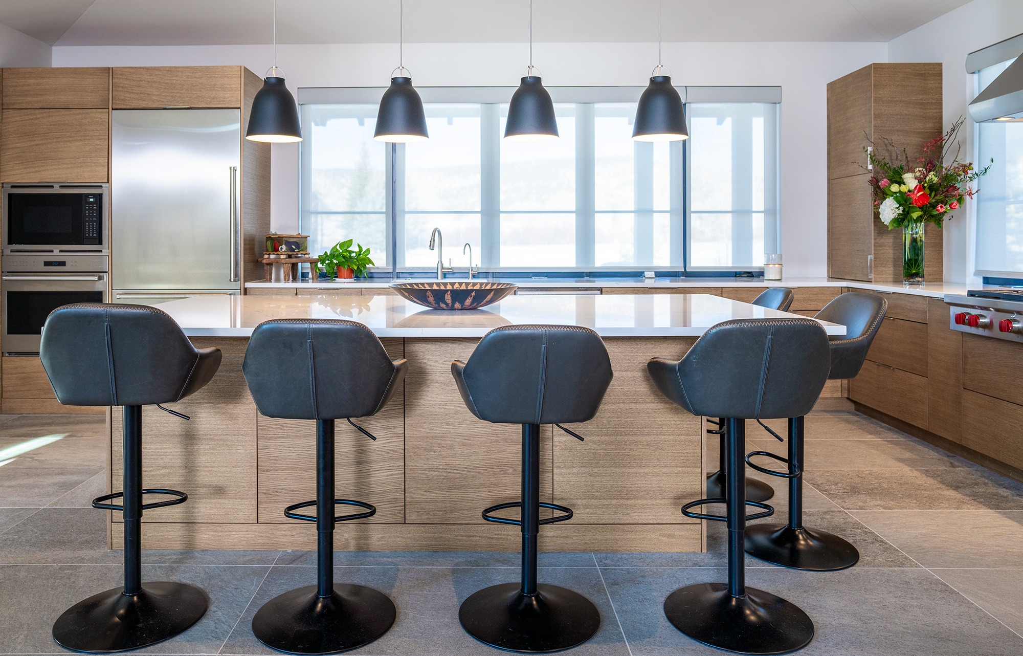 BJD custom home kitchen with barstools, countertop, windows backsplash all head on