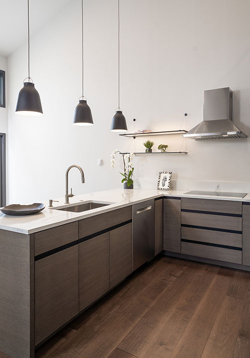 Singletree townhome remodel - remodeled kitchen, black pendant lighting, gray cabinetry, wood flooring