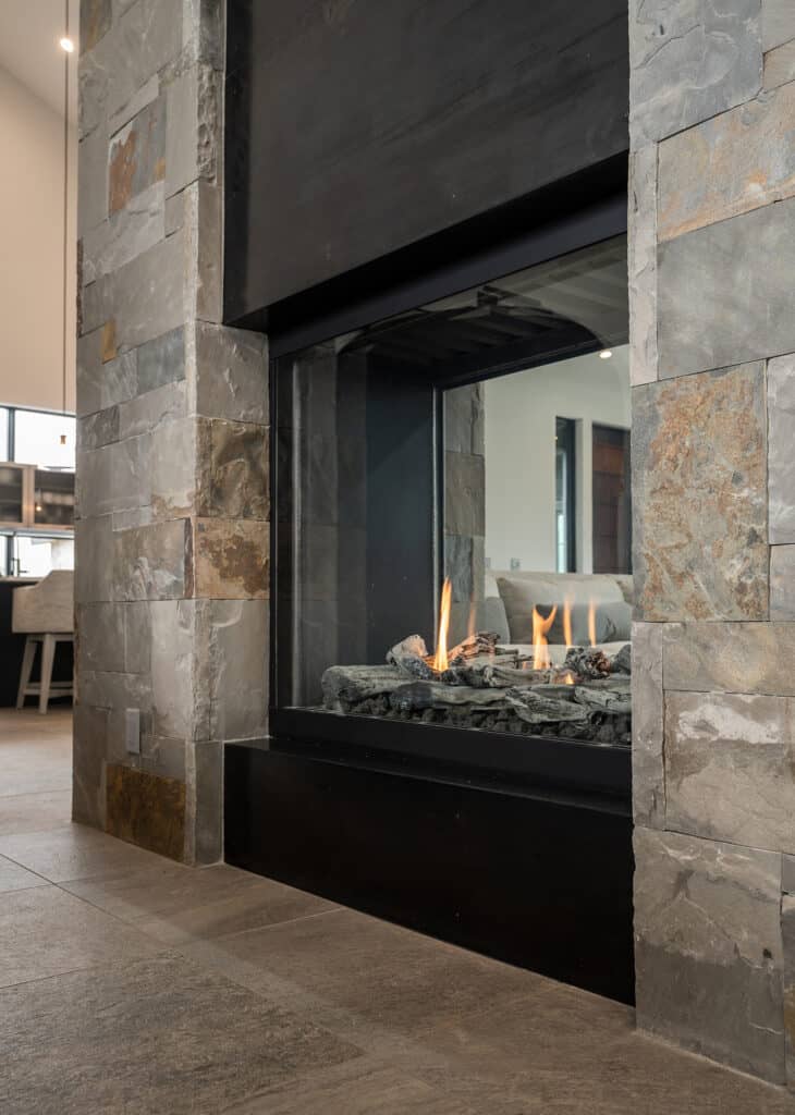 Steel and stone combo two-sided fireplace. 